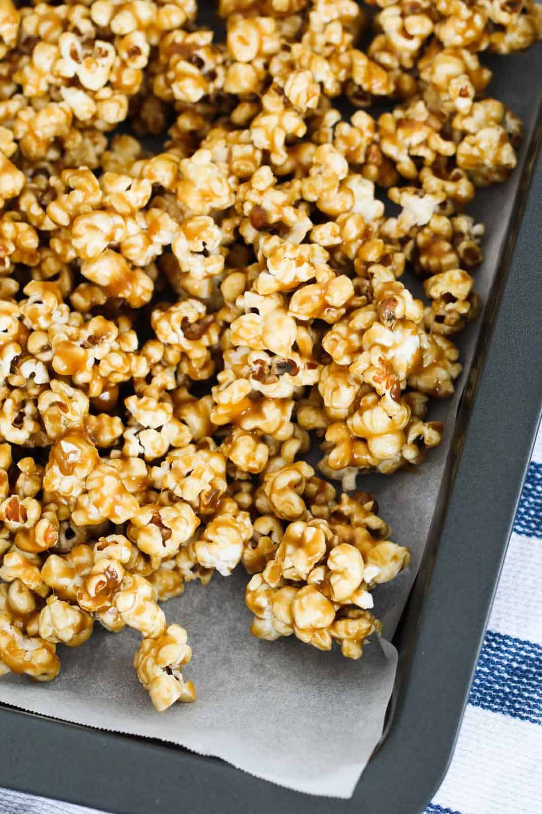 Salted caramel popcorn on a tray covered with parchment paper