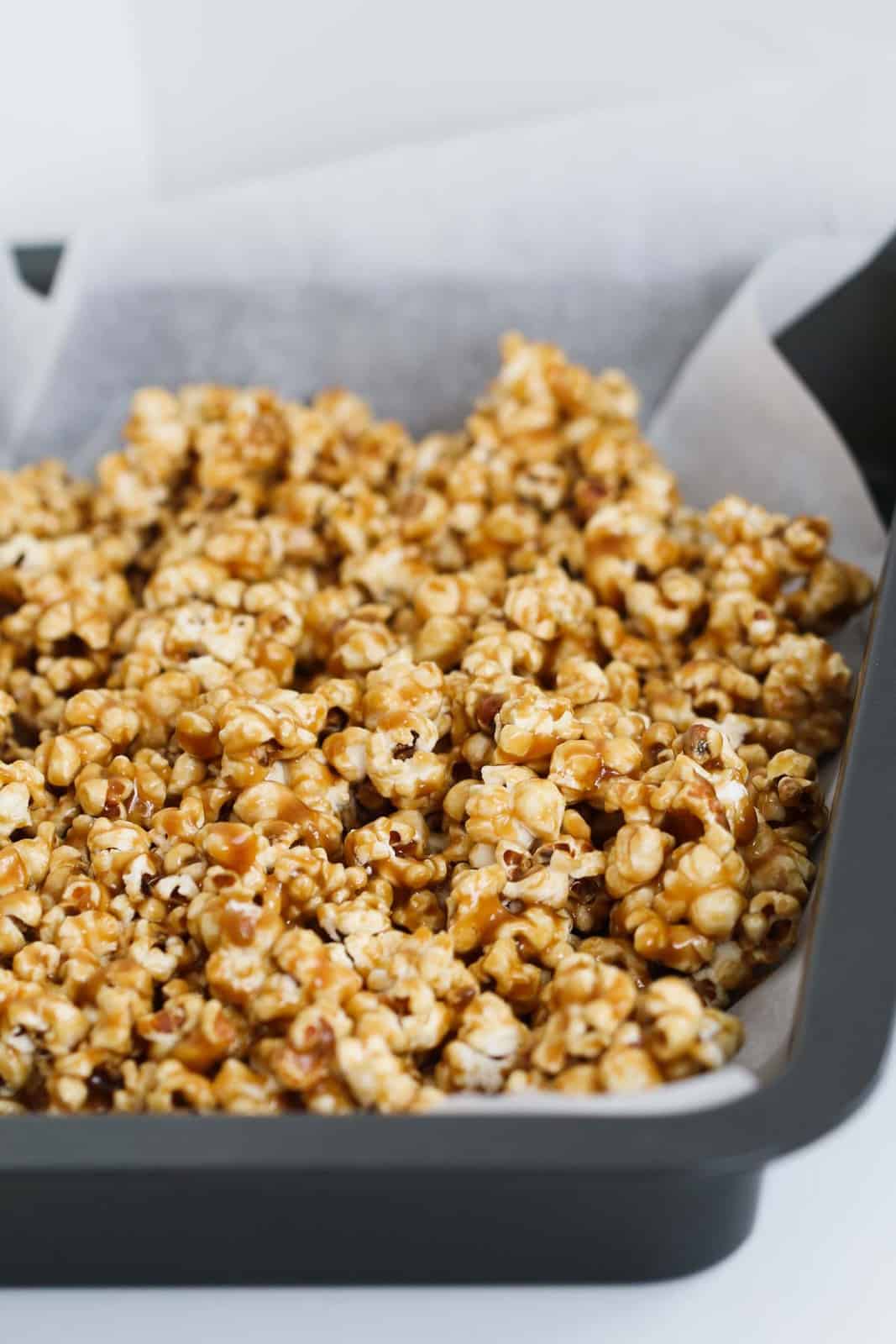 Caramel popcorn with salt on a tray covered with parchment paper