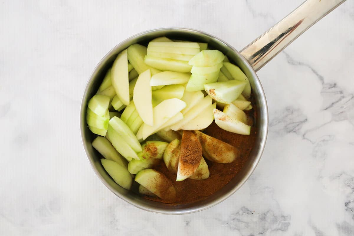 A pot full of apples and spices to be stewed