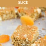 Pieces of oat slice with apricots on baking paper with the text overlay 'Apricot Oat Slice'