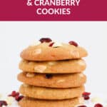 A Pinterest image with a stack of cookies with white chocolate chips and cranberries.