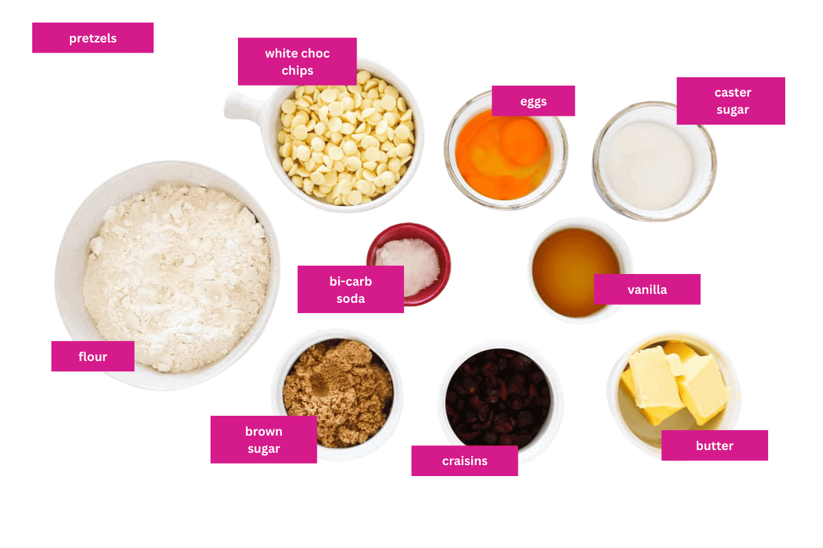 The ingredients for cranberry and white chocolate cookies in small bowls.