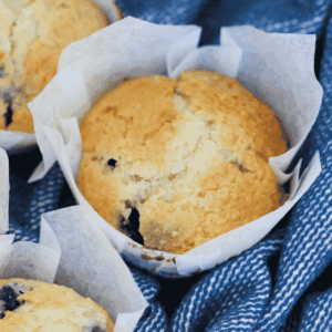 A sugar-topped muffin with blueberries mixed throughout.