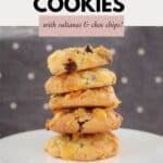 A stack of crunchy Conrflake Cookies with sultanas and chocolate chips, on a cake stand.