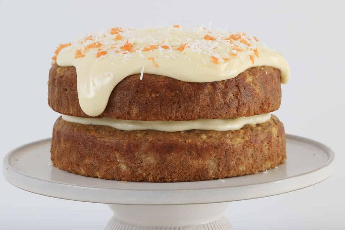 A two layered carrot cake with cream cheese frosting.