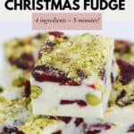 Small squares of white chocolate fudge, decorated with chopped pistachios and dreid cranberries.