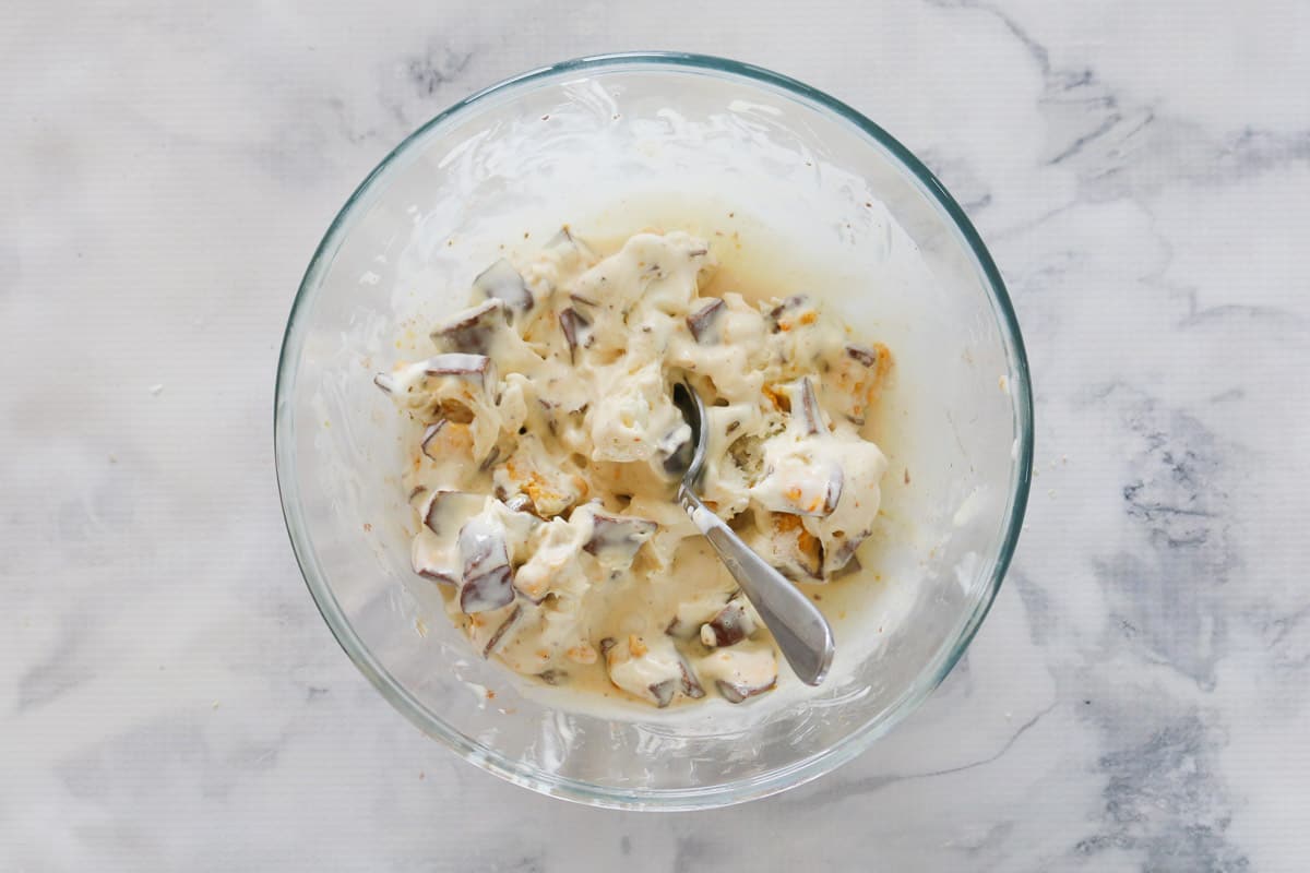 A bowl of vanilla ice-cream with chopped honeycomb mixed through.