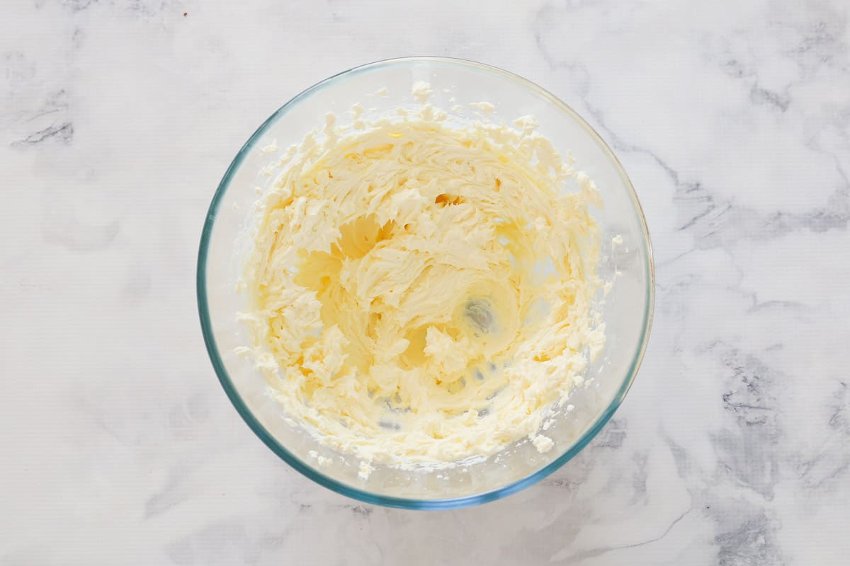 Beaten cream cheese in a bowl.