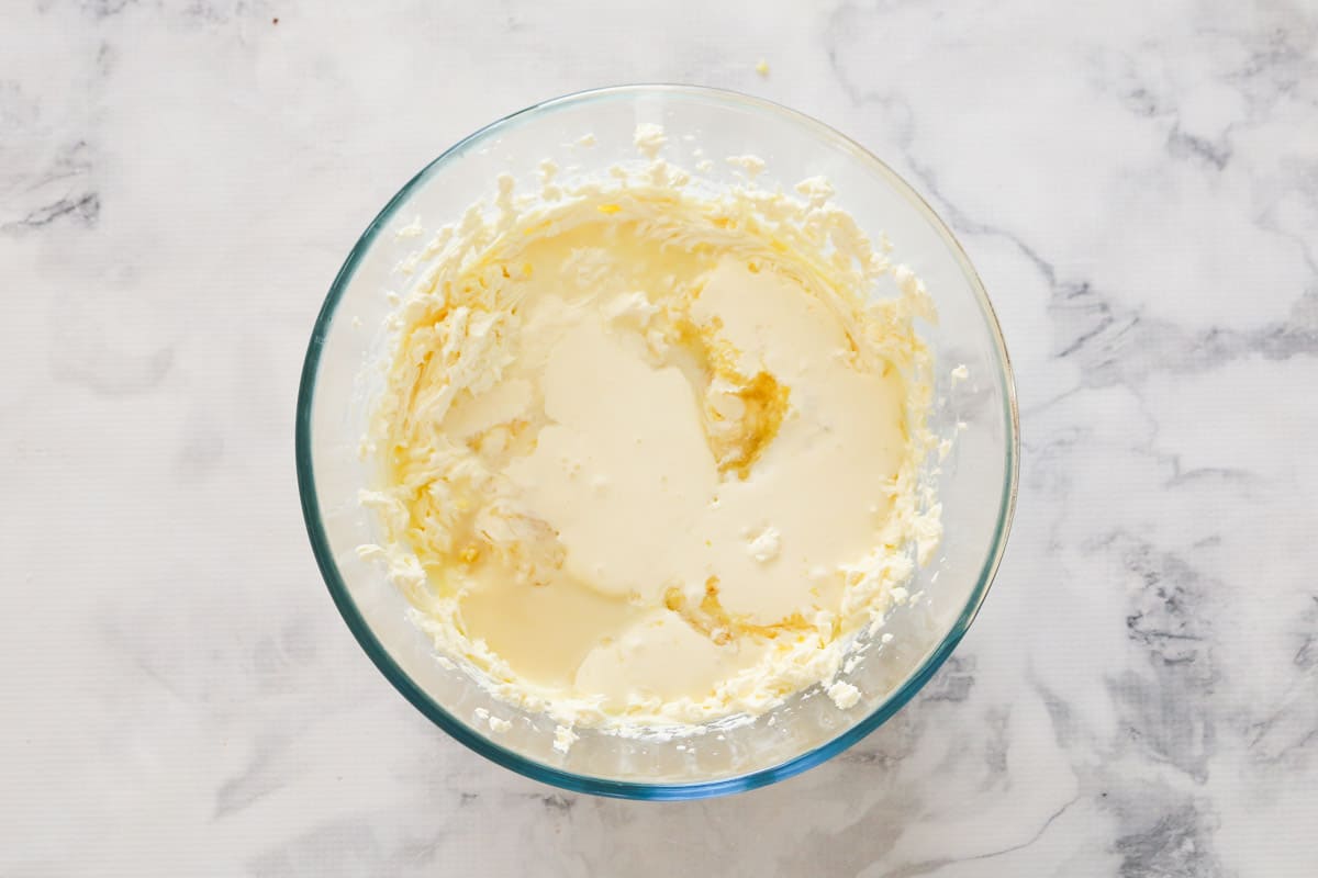 Cream cheese, lemon juice and zest, sweetened condensed milk and gelatine in a bowl.
