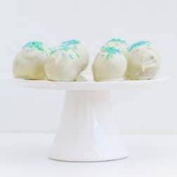 White chocolate balls on a cake plate.