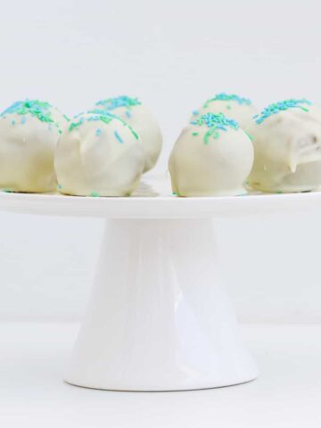 White chocolate balls on a cake plate.