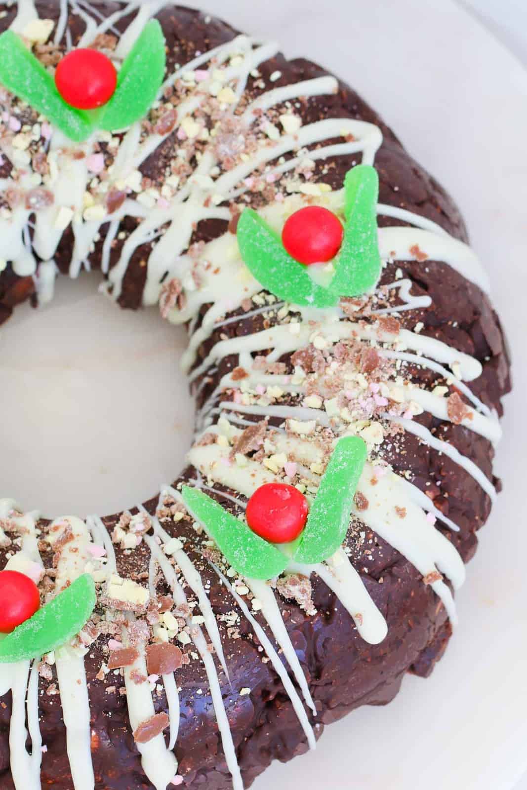A rocky road wreath with candy Christmas decorations to resemble holly leaves and berries.