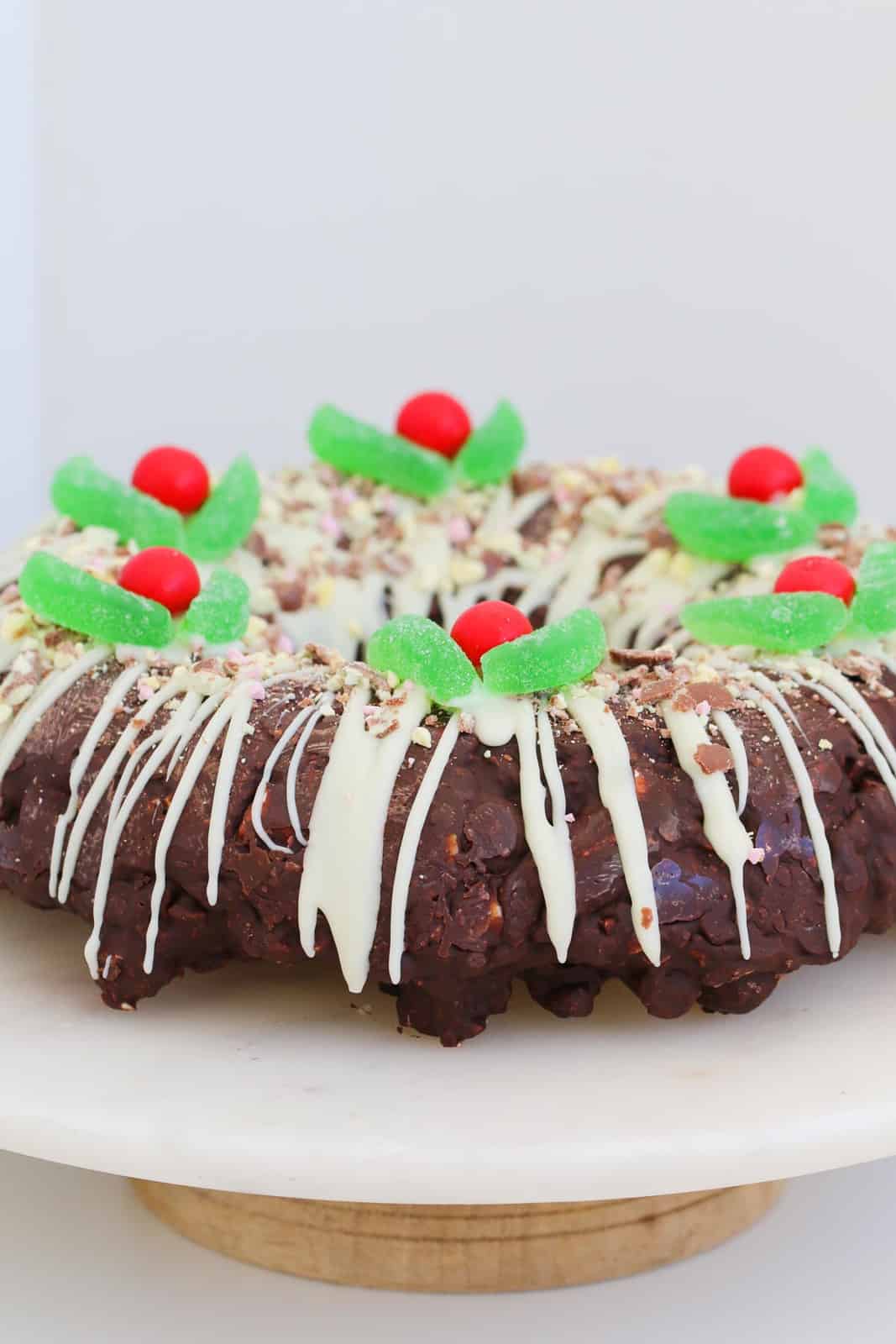 A chocolate rocky road shaped and decorated as a Christmas wreath.
