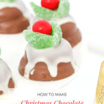 A white plate with chocolate marshmallow biscuits decorated to look like a Christmas chocolate pudding.