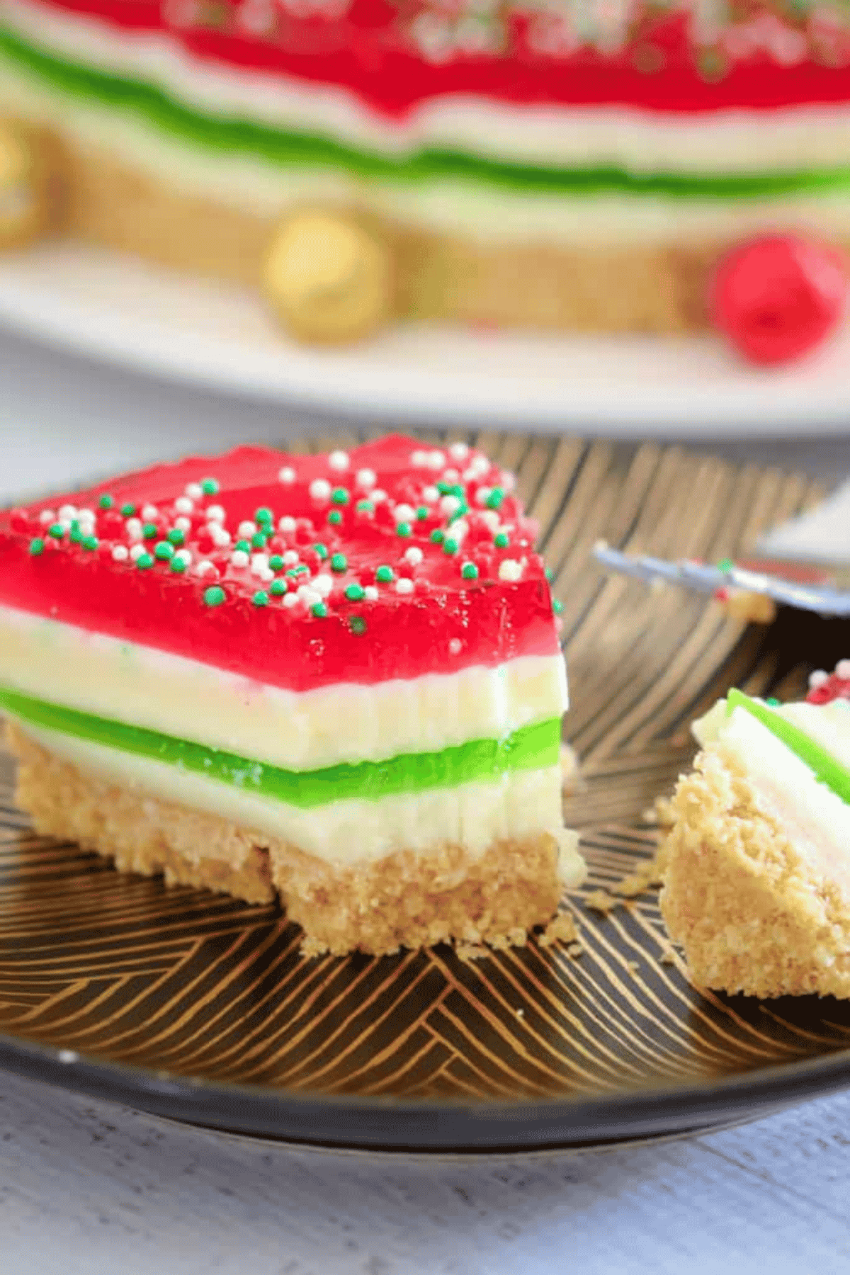 A half eaten slice of Christmas jelly cake.