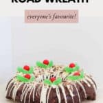 A rocky road wreath drizzled with white chocolate and decorated with spearment leaves and jaffes, to resemble holly.