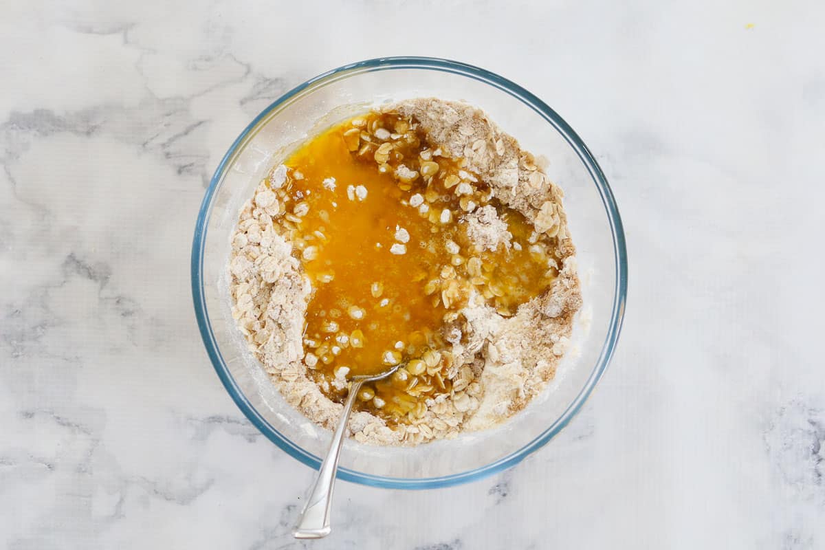 Butter and rolled oats mixed in a glass bowl