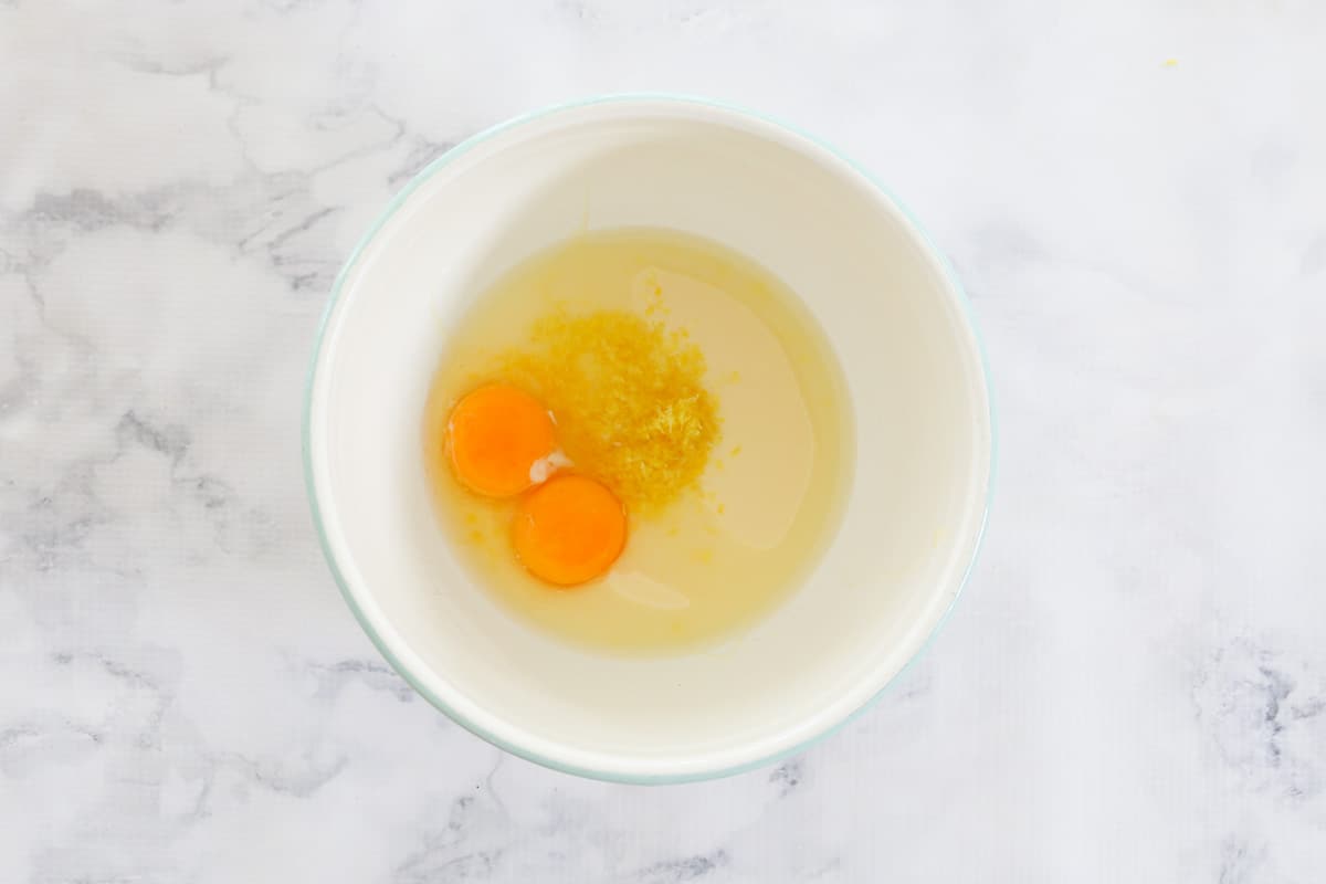 Egg yolks and wet ingredients in a white bowl