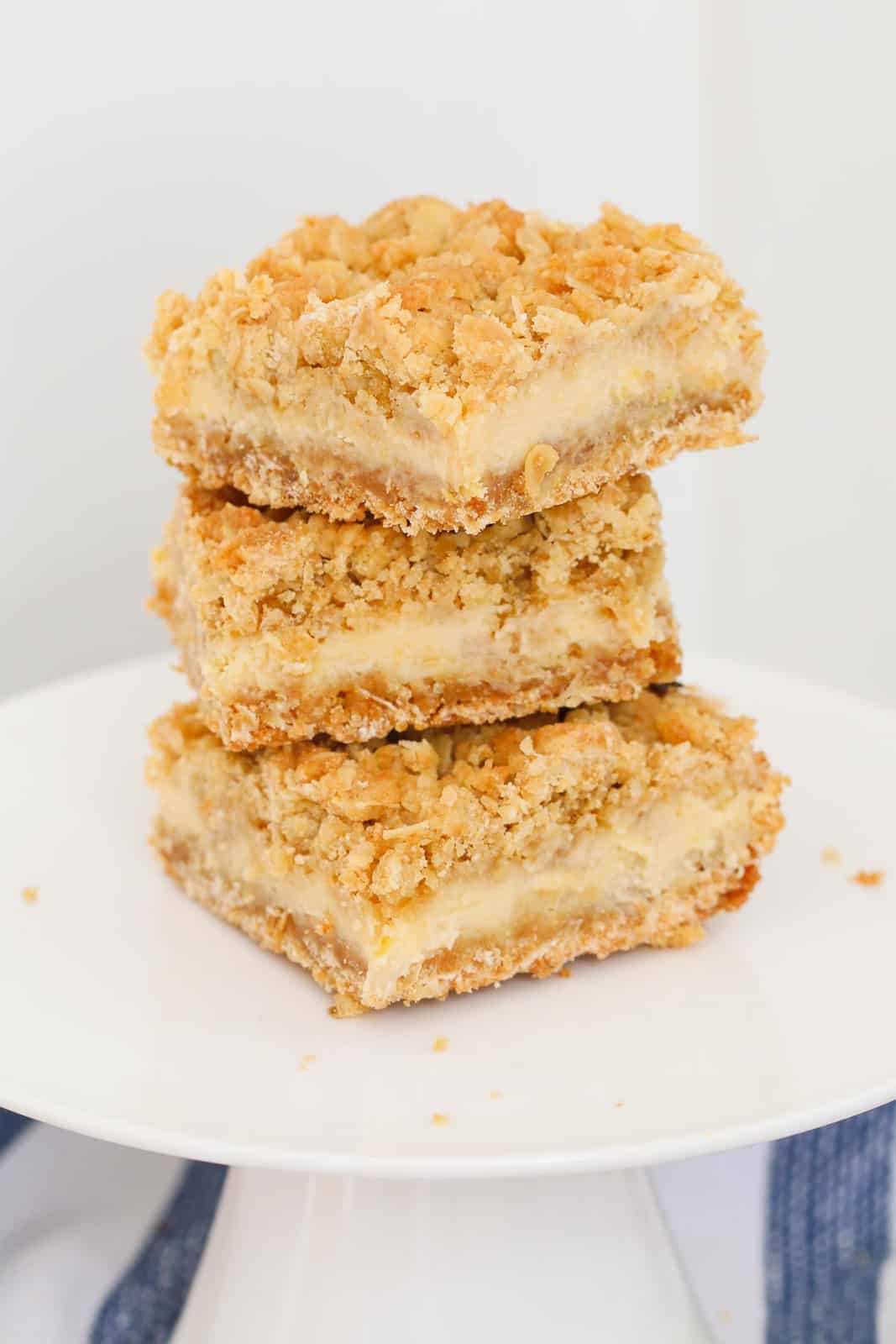 Creamy Lemon Crumble Bars stacked on a plate