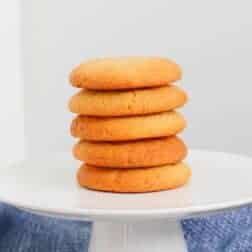 A stack of honey biscuits on a white plate.