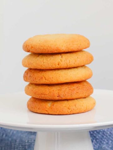 A stack of honey biscuits on a white plate.