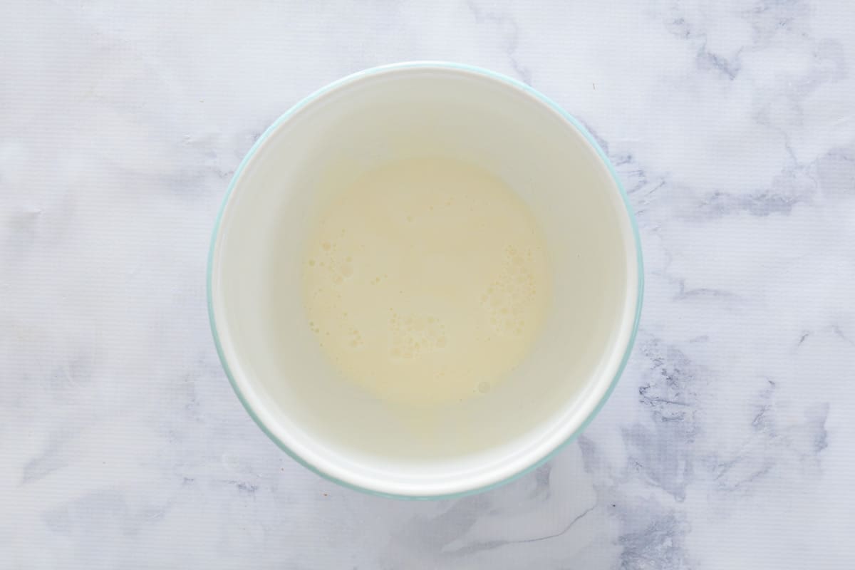 An overhead shot of lemonade and milk mixture in white mixing bowl