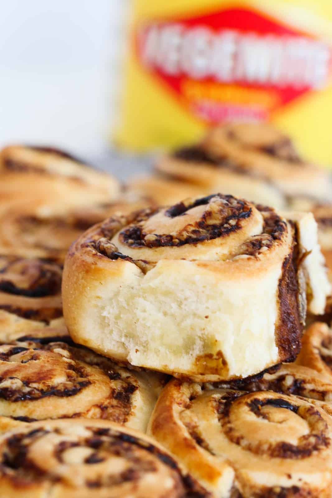 A pile of cheese and Vegemite scrolls with one placed on top.