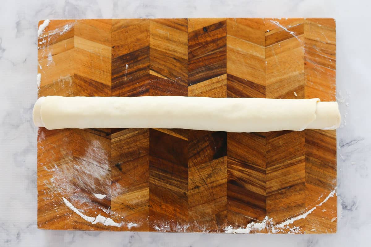 Scroll dough with fillings enclosed, rolled into a log.