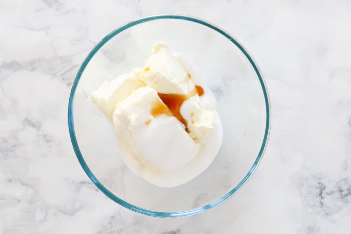 Cream cheese, sugar and vanilla in a bowl.