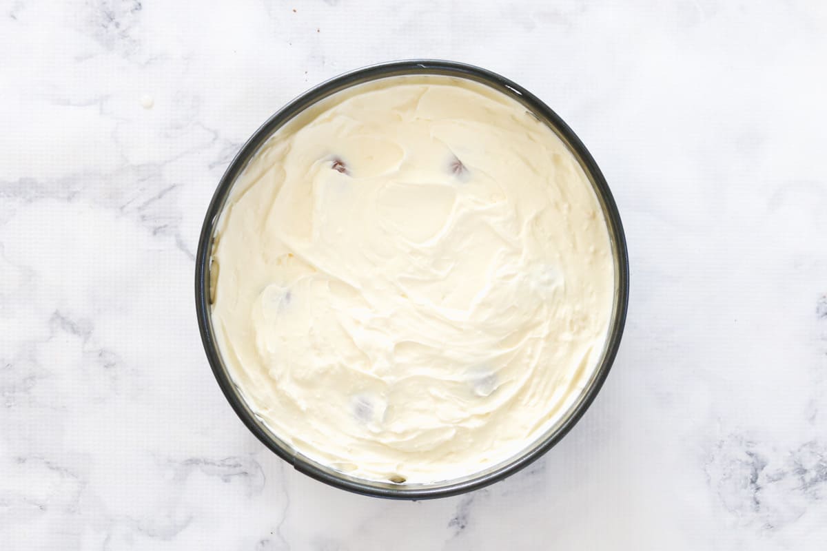 White chocolate cheesecake mixture in a springform pan.