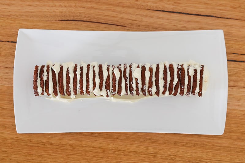 A log of chocolate biscuits wedged together with whipped cream.