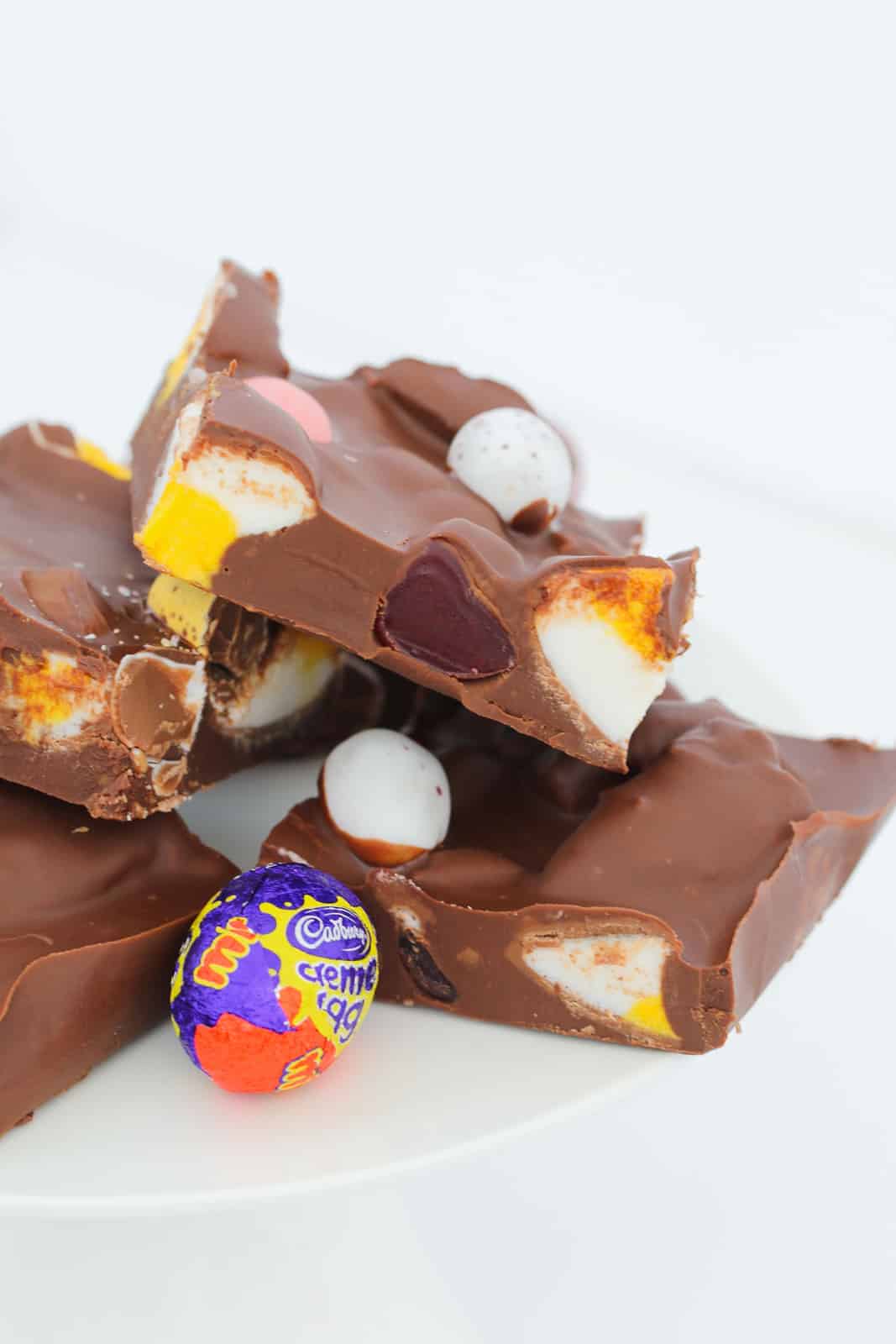 Pieces of Easter rocky road filled with raspberry lollies, Creme Eggs and marshmallows.