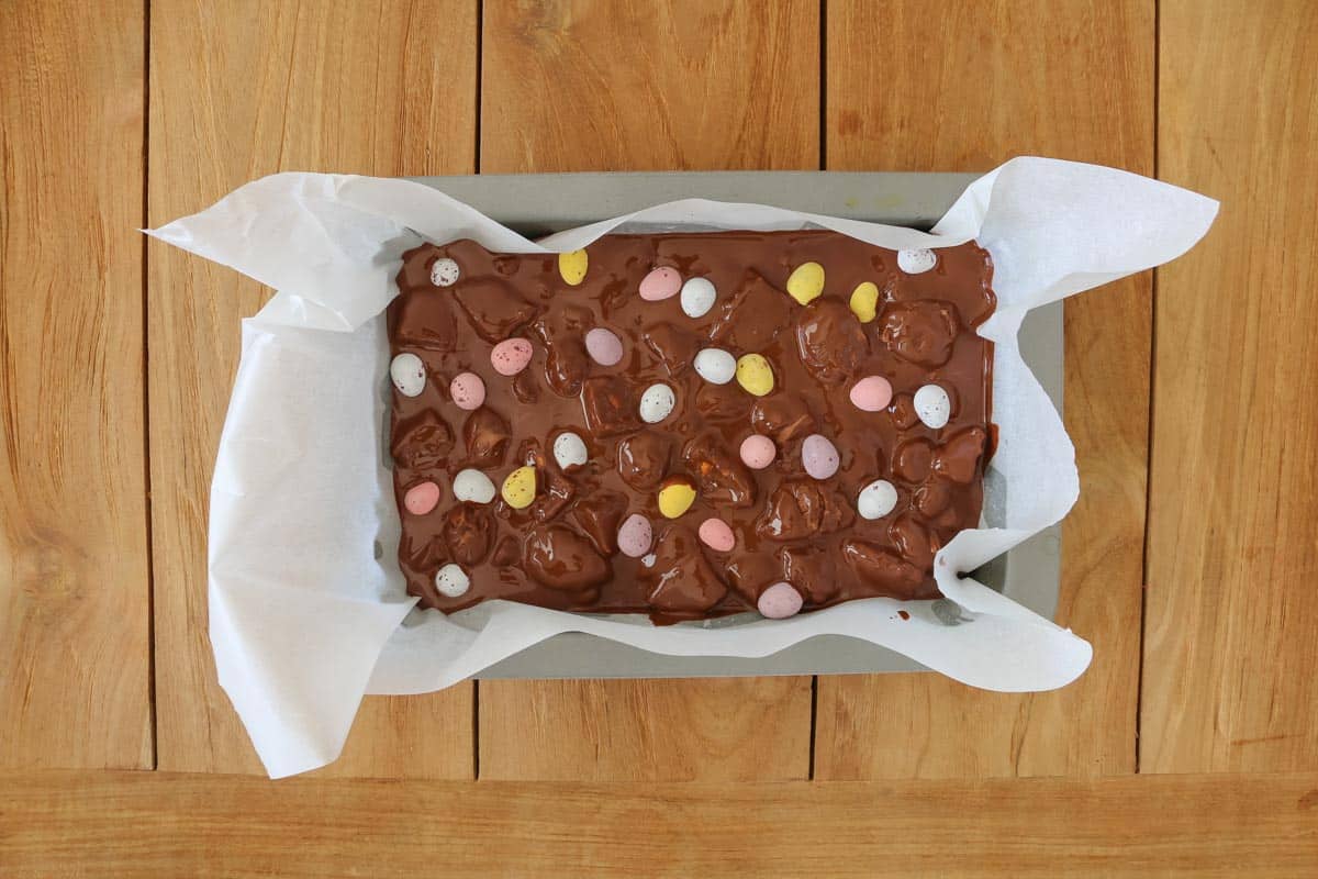 Easter eggs on top of a chocolate rocky road slice.