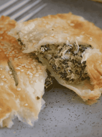 Two puff pastries filled with spinach, ricotta and feta.