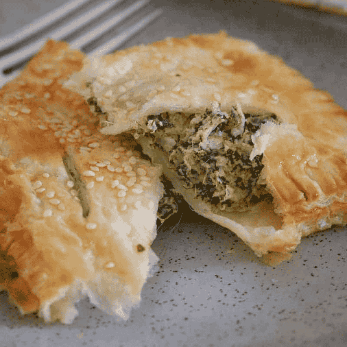 Two puff pastries filled with spinach, ricotta and feta.