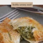 A spinach puff pastry parcel cut in half to show filling.