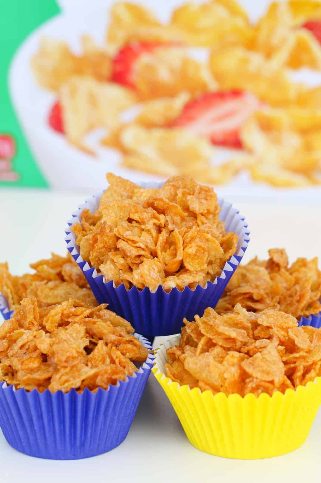 Five Honey Joys in coloured cases with a box of Corn Flakes in the background.