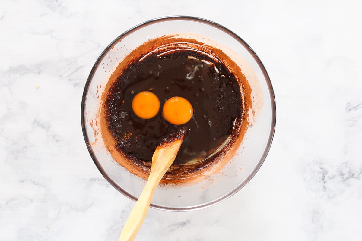 Brownie batter with two eggs added to bowl