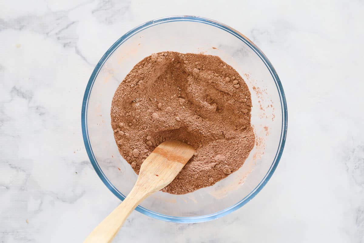 Cocoa powder, flour and brown sugar mixed together with wooden spoon