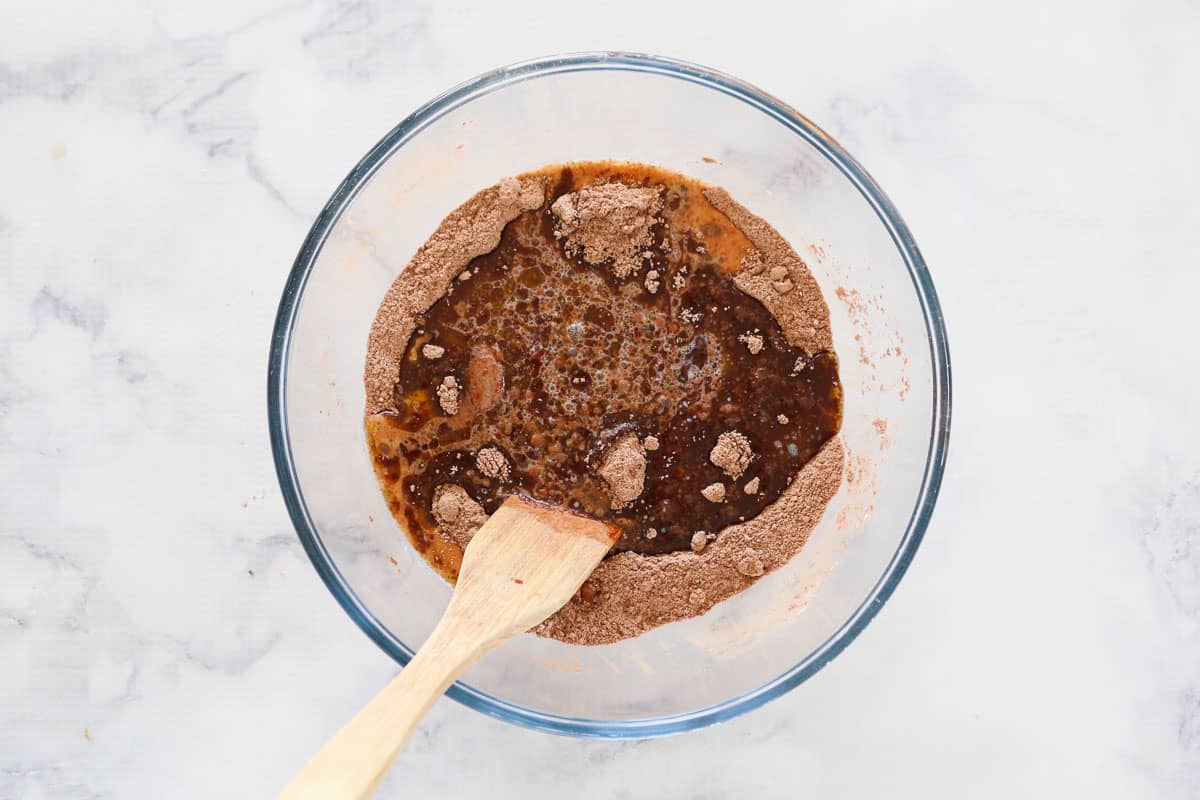 Cocoa powder being mixed with liquid ingredients