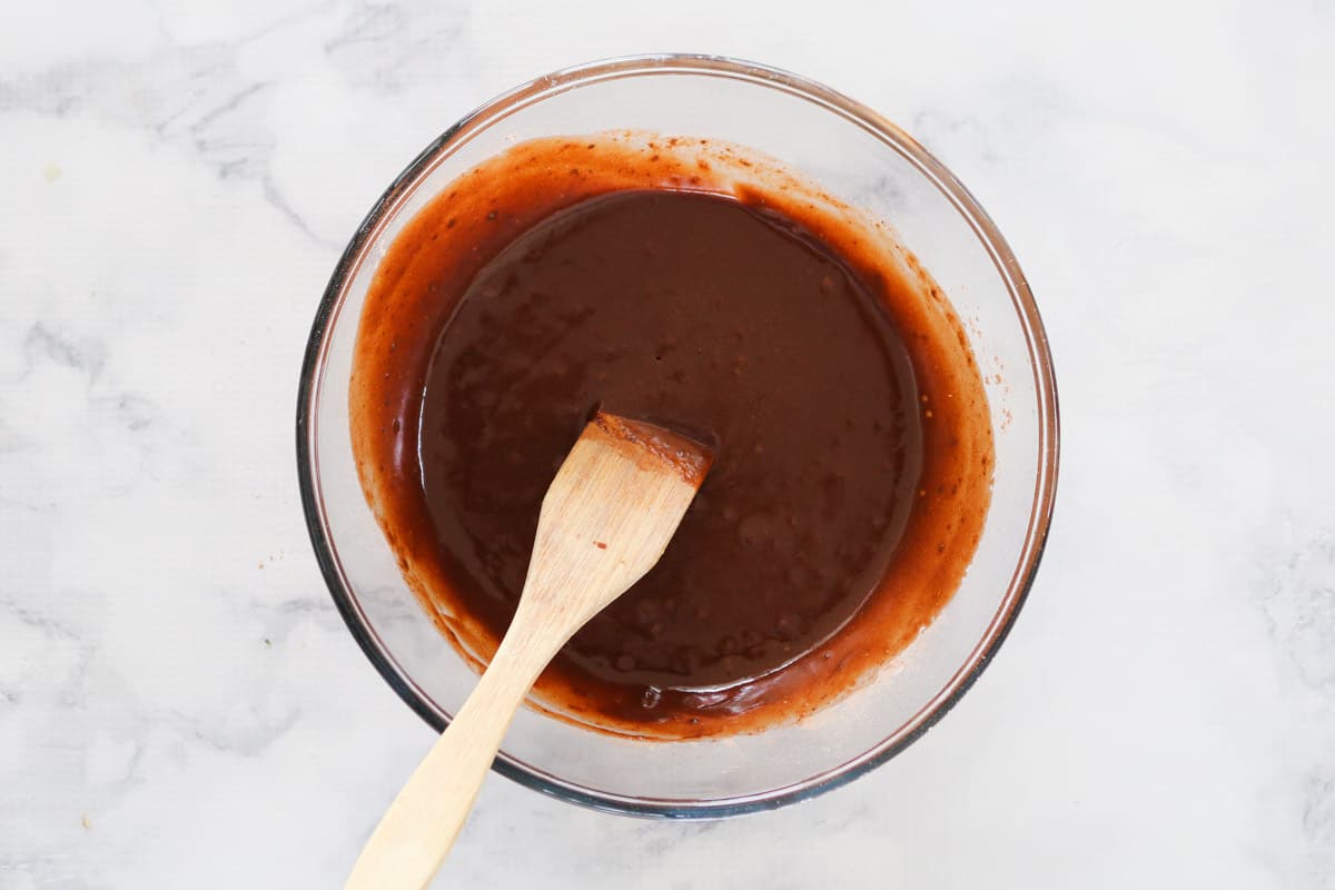 Top view of brownie batter with wooden spoon