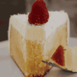 A slice of half-eaten white chocolate mud cake.