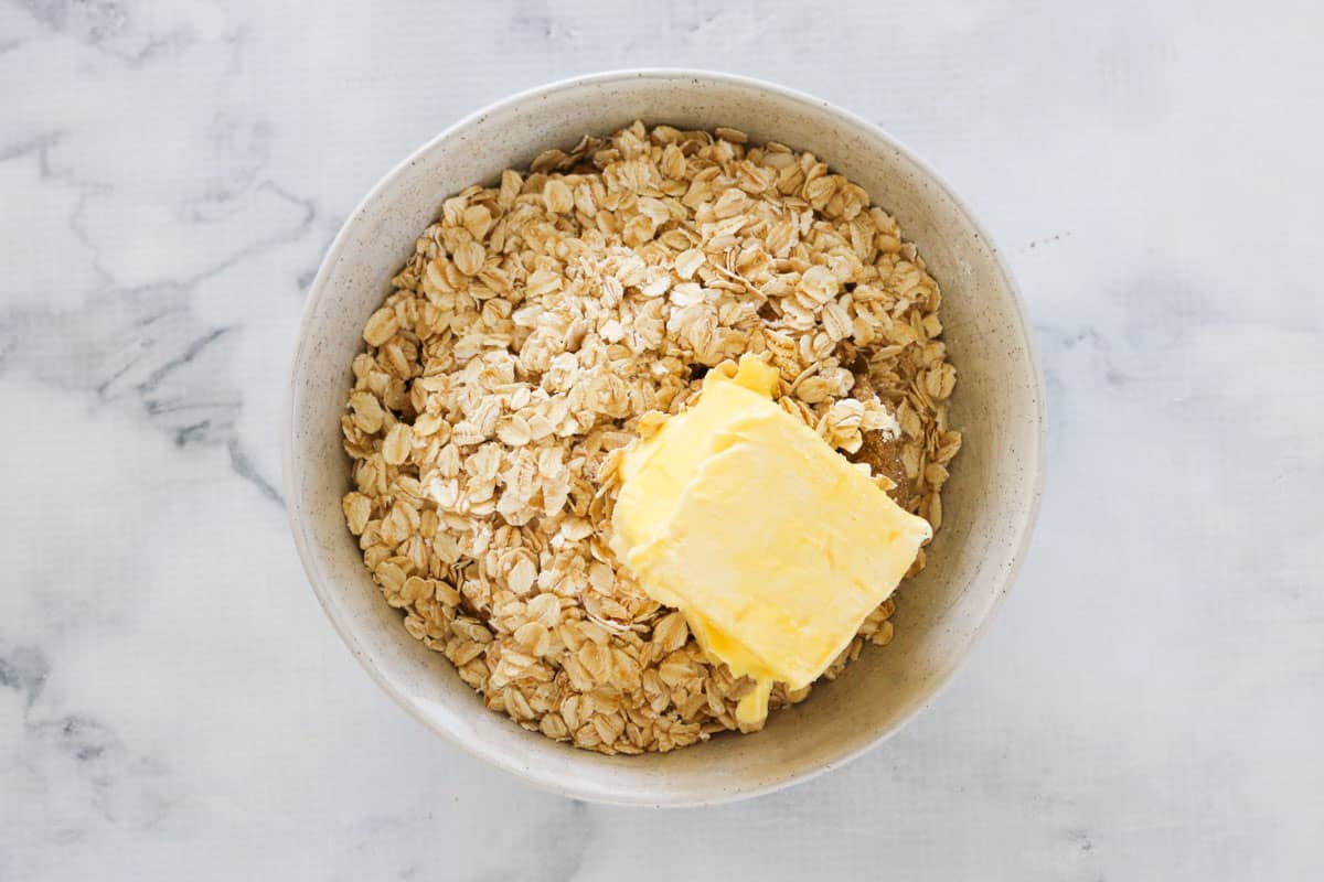 Rolled oats and butter in a bowl, to make crumble topping