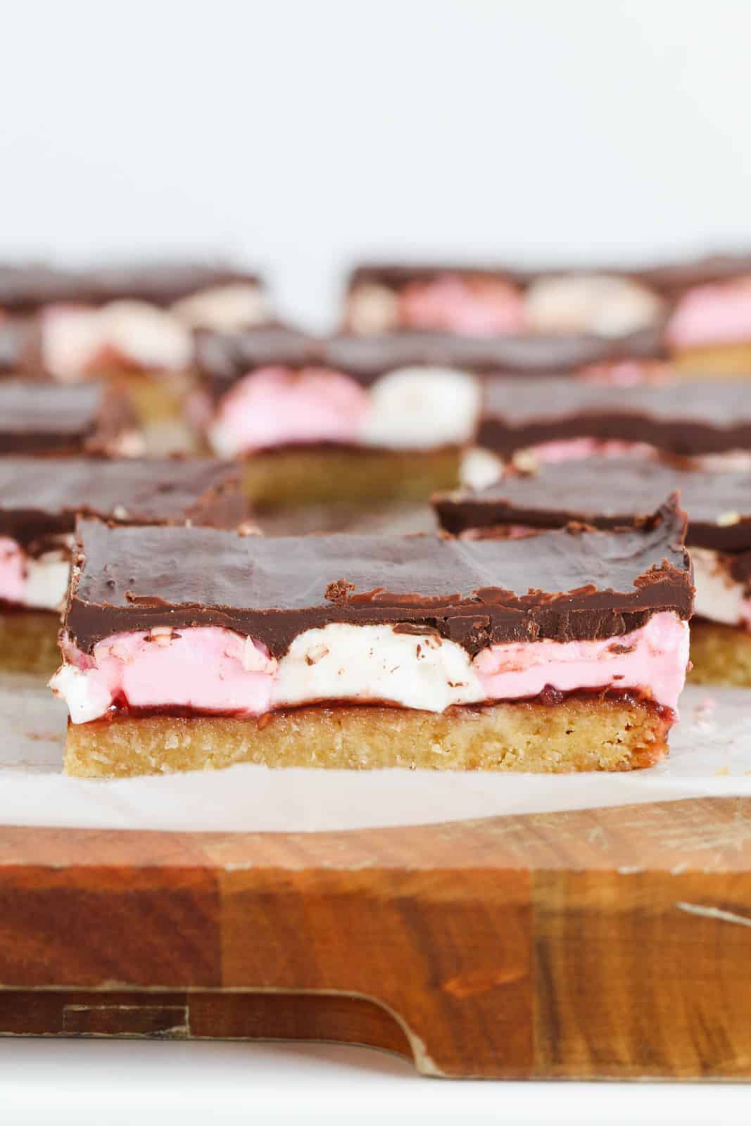 Marshmallow slice sitting on a wooden chopping board