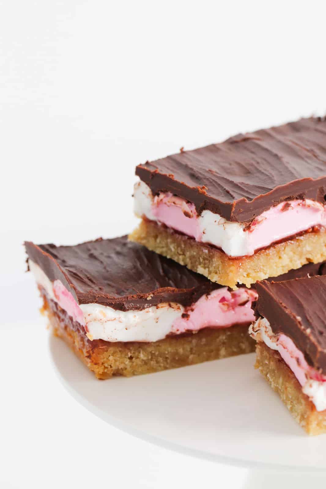 A close up of a stack of marshmallow chocolate slices.