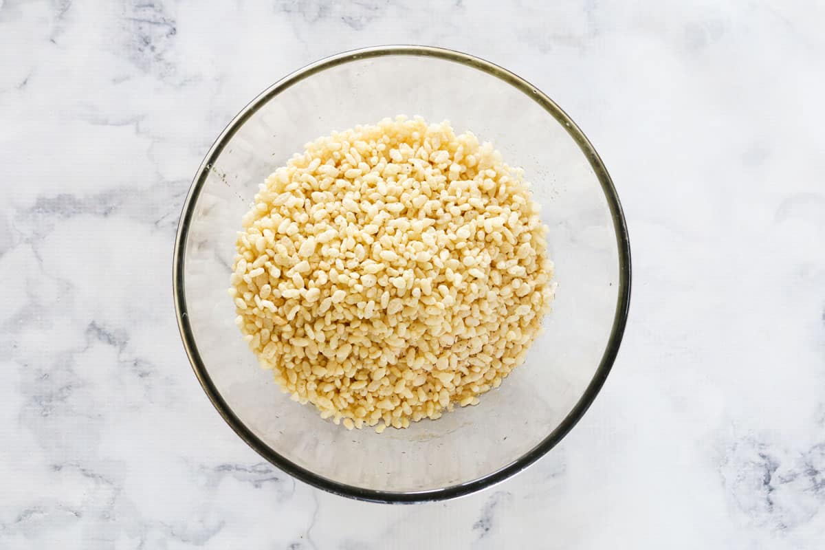 Puffed rice bubbles in a glass bowl on a marble counter