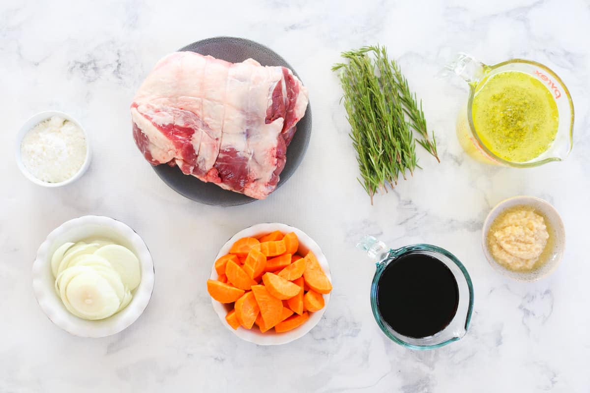 The ingredients for a slow cooker roast lamb with red wine, garlic and rosemary.