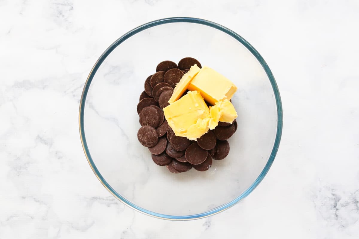 Dark chocolate melts and butter in a glass mixing bowl