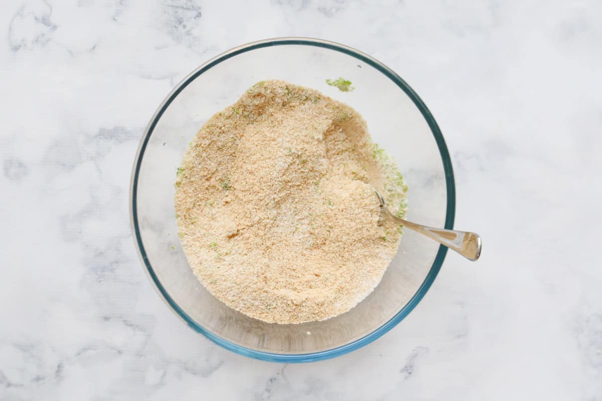 Mixed crushed biscuits, coconut & lime zest in a glass bowl