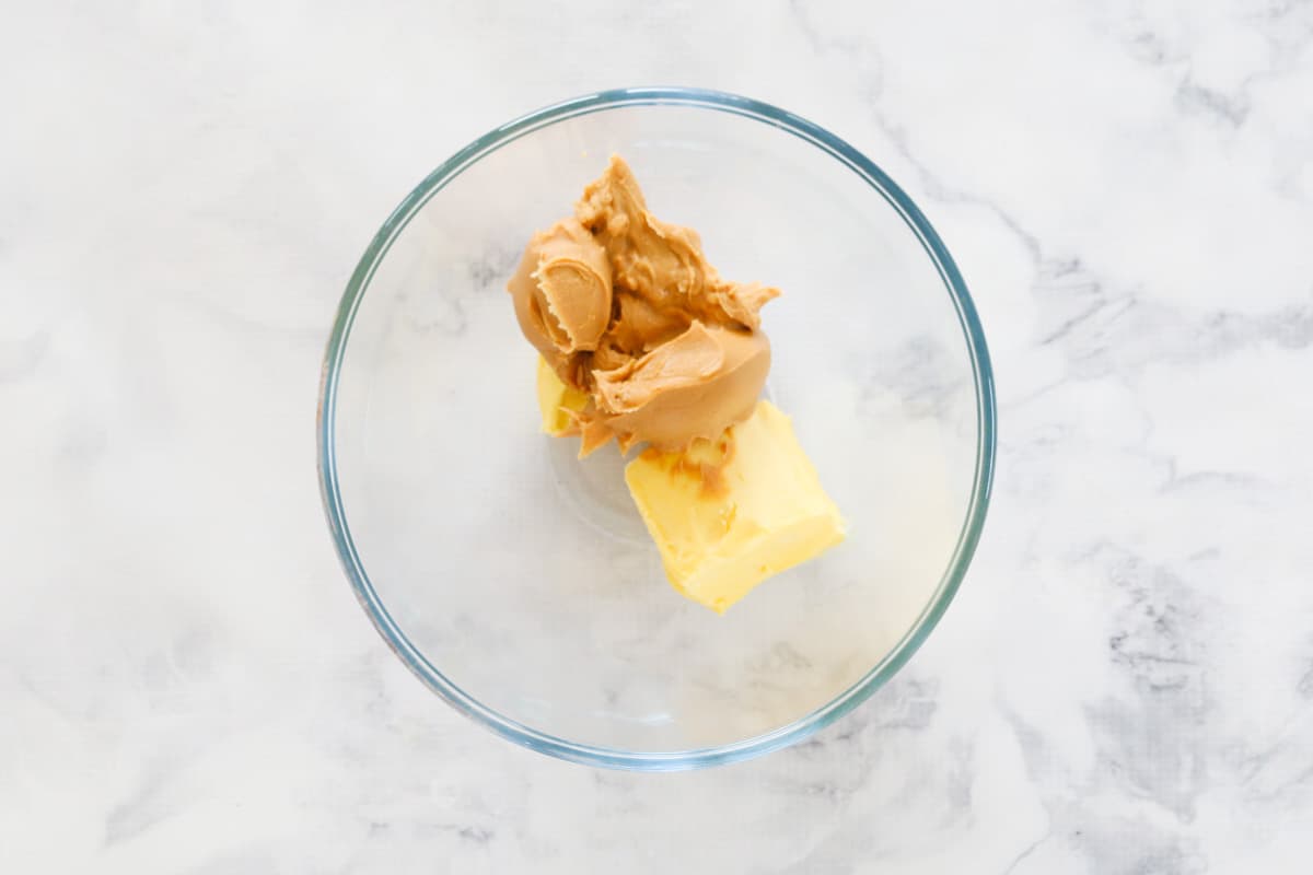 Butter and peanut butter in a glass bowl.